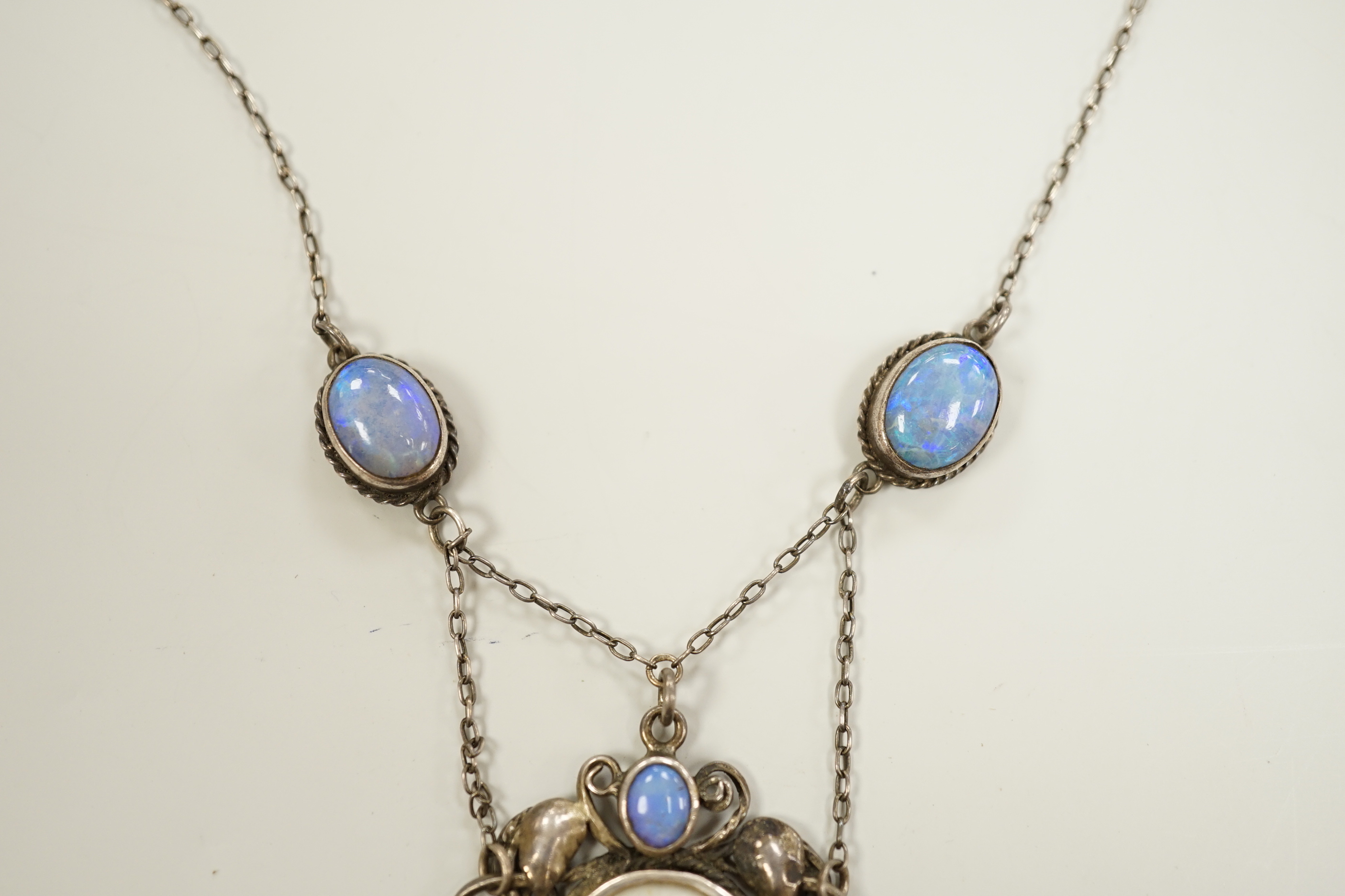 An Arts & Crafts white metal, mother of pearl and gem set drop pendant necklace, in the manner of Sybil Dunlop, overall 56cm.